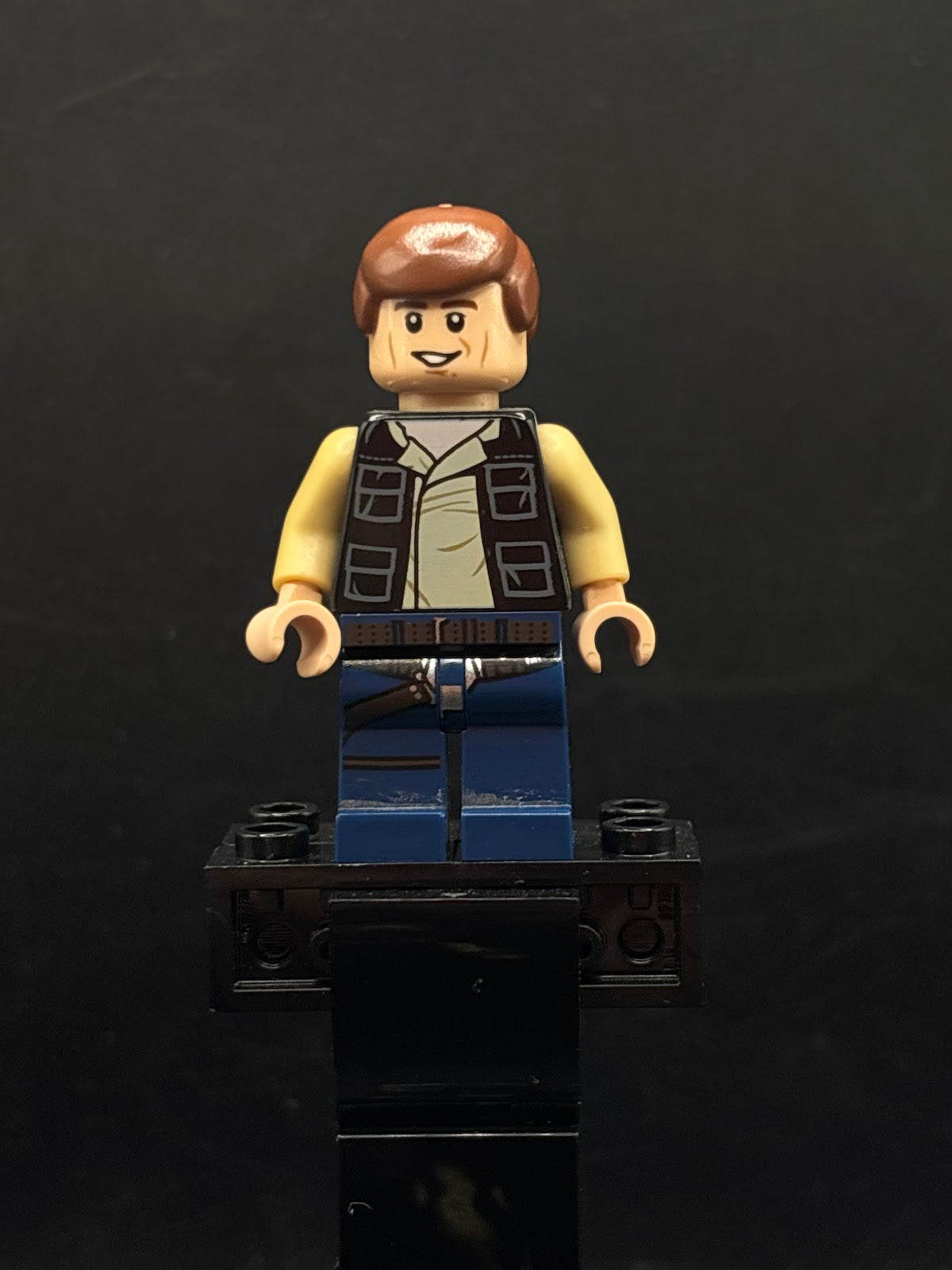 Han Solo - Black Vest with Pockets over Tan Shirt with Dark Tan Creases, Dark Blue Legs with Belts, Smooth Hair - Foto real - DagaBlocks